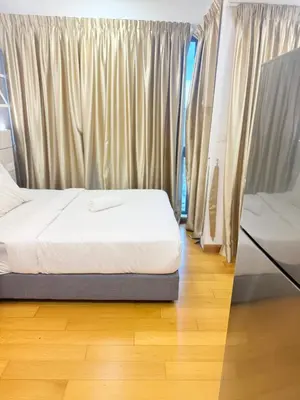a bedroom with a bed and a window at Colony Suites KL by Sopping Centre in Kuala Lumpur