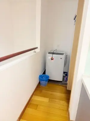 a small refrigerator in a room with a wooden floor at Colony Suites KL by Sopping Centre in Kuala Lumpur