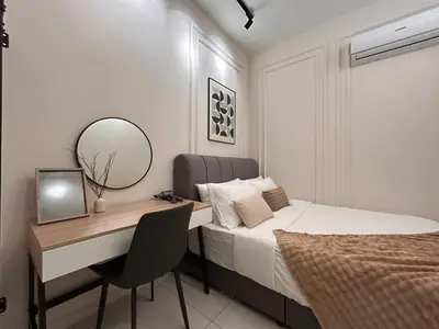 a bedroom with a desk and a bed and a mirror at Majestic Residence by Manhattan Group in Kuala Lumpur