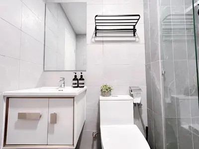 a white bathroom with a sink and a toilet at Majestic Residence by Manhattan Group in Kuala Lumpur