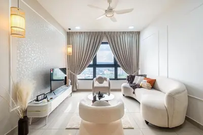 a living room with a couch and a tv at Cozy Home to explore KL City KLCC TRX Bkt Bintang in Kuala Lumpur
