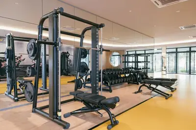 a gym with rows of treadmills and machines at Cozy Home to explore KL City KLCC TRX Bkt Bintang in Kuala Lumpur
