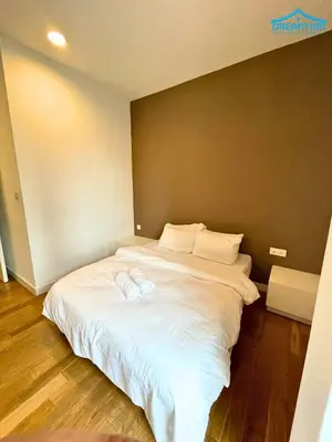 a large white bed in a room with wooden floors at Platinum Suites KLCC by Dream'Inn in Kuala Lumpur