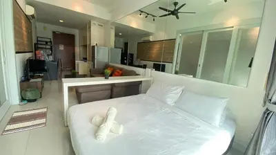 a bedroom with a white bed with pillows on it at 3-10mins to klcc -pavilion -premium studio 2-4pax in Kuala Lumpur
