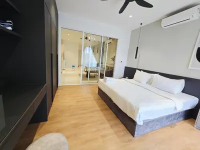 a bedroom with a large white bed and a mirror at Quill Residence Queen House in Kuala Lumpur