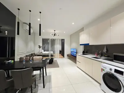 a kitchen and living room with a table and a dining room at Quill Residence Queen House in Kuala Lumpur