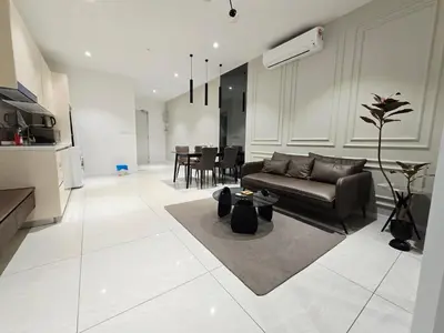 a living room with a couch and a table at Quill Residence Queen House in Kuala Lumpur