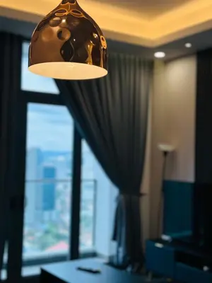 a lamp in a hotel room with a window at Royce Residence KLCC by ABM Unique in Kuala Lumpur