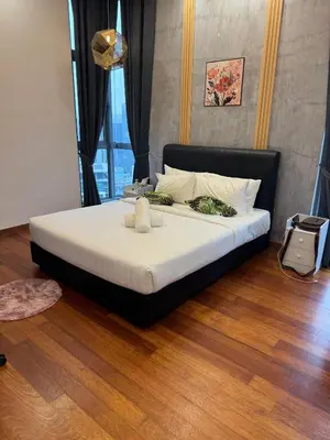 a bed with white sheets and pillows in a room at Royce Residence KLCC by ABM Unique in Kuala Lumpur