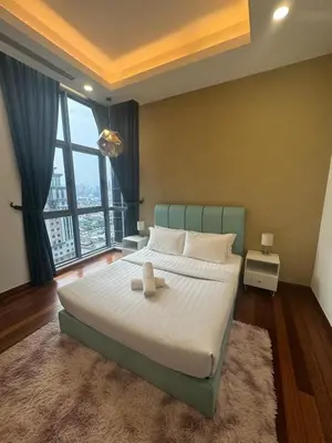 a bedroom with a large bed and a large window at Royce Residence KLCC by ABM Unique in Kuala Lumpur
