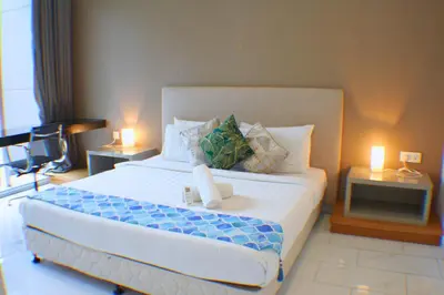 a bedroom with a large bed and a television at The Platinum Galaxy Suites KLCC in Kuala Lumpur