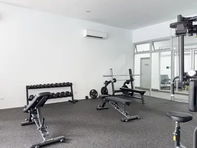 a gym with several tread machines in a room at Chan Sow Lin - Cozy 3B3B - 6 pax - F&B & Mart in Kuala Lumpur