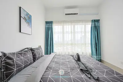 a bedroom with a bed with green curtains and a window at Chan Sow Lin - Cozy 3B3B - 6 pax - F&B & Mart in Kuala Lumpur