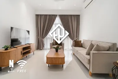 a living room with a couch and a tv at Elegant 2BR Residence at MET 1 in Kuala Lumpur