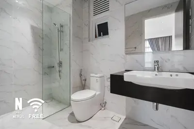 a bathroom with a toilet and a sink and a shower at Elegant 2BR Residence at MET 1 in Kuala Lumpur