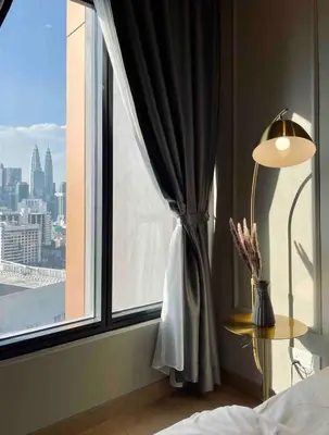 a bedroom with a window with a view of the city at Lucentia Suties Rooftop pool by Lalaport KL in Kuala Lumpur