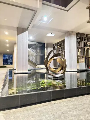 a lobby with a large spiral sculpture in the middle at Lucentia Suties Rooftop pool by Lalaport KL in Kuala Lumpur