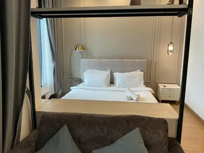 a bedroom with a large bed with white pillows at Lucentia Suties Rooftop pool by Lalaport KL in Kuala Lumpur
