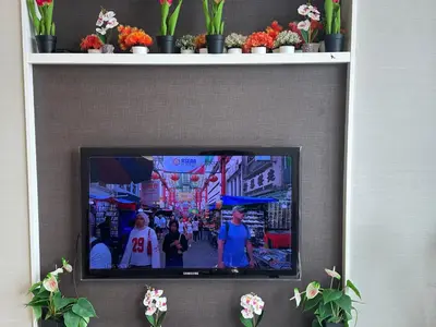 a tv on a wall with a picture of a street at Global Suites at Platinum kLCC in Kuala Lumpur