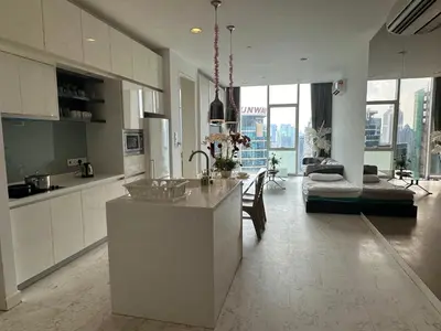 a kitchen and living room with a table and a couch at Global Suites at Platinum kLCC in Kuala Lumpur