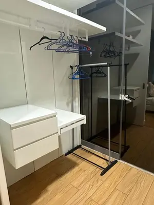 a room with white shelves and a white desk at Global Suites at Platinum kLCC in Kuala Lumpur