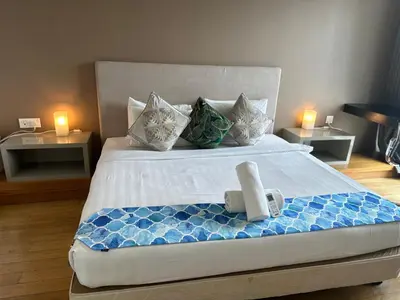 a bedroom with a large bed with two tables at Global Suites at Platinum kLCC in Kuala Lumpur