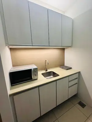 a kitchen with a sink and a microwave at Swiss Garden Resident By FA in Kuala Lumpur