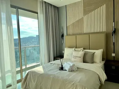 a bedroom with a large bed with a large window at Dorsett Hartamas - Luxury Studio with Bathtub in Kuala Lumpur