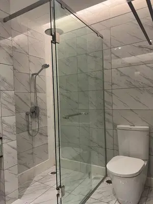 a bathroom with a toilet and a glass shower at Dorsett Hartamas - Luxury Studio with Bathtub in Kuala Lumpur