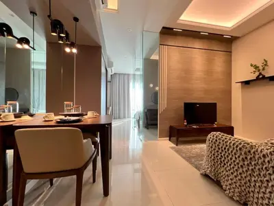 a dining room with a table and a television at Dorsett Hartamas - Luxury Studio with Bathtub in Kuala Lumpur