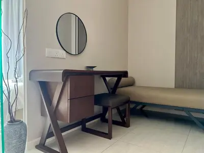 a bathroom with a sink and a mirror and a chair at Dorsett Hartamas - Luxury Studio with Bathtub in Kuala Lumpur