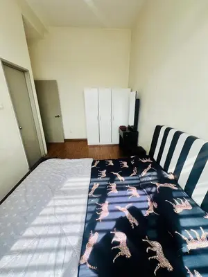 a bedroom with a bed with a dinosaur blanket on it at KLCC View Apartment in Kuala Lumpur