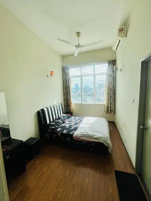 a bedroom with a bed in a room with a window at KLCC View Apartment in Kuala Lumpur