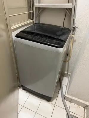 a small refrigerator with a stove in a kitchen at KLCC View Apartment in Kuala Lumpur