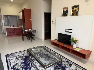 a living room with a television and a table at KLCC View Apartment in Kuala Lumpur