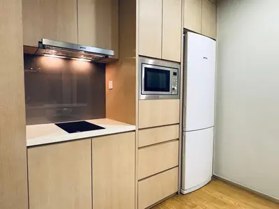 a kitchen with a refrigerator and a microwave at 188 suites Apartment with KLCC View by Vho'Z in Kuala Lumpur