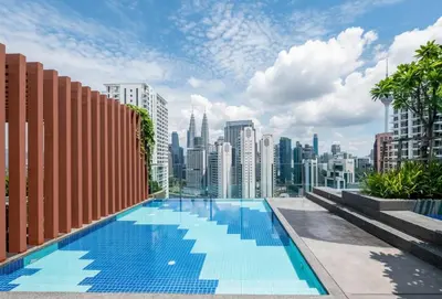 a swimming pool with a city skyline in the background at Majestic Residence near KLCC Quill City 1 in Kuala Lumpur