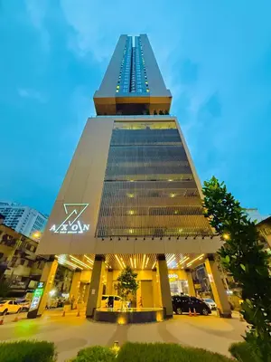 a large building with a tall tower with lights at Akson Residensi Axon Bukit Bintang by TaheeenS in Kuala Lumpur