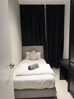a bed in a room with black curtains at Akson Residensi Axon Bukit Bintang by TaheeenS in Kuala Lumpur