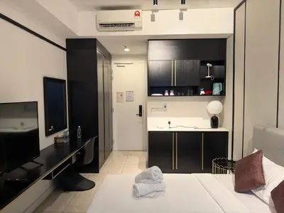 a small room with a bed and a kitchen at Akson Residensi Axon Bukit Bintang by TaheeenS in Kuala Lumpur