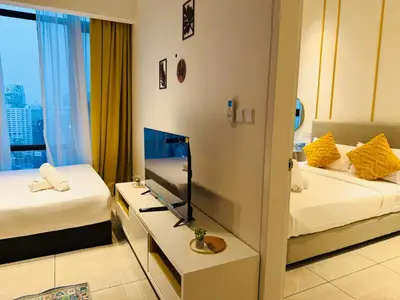 a hotel room with two beds and a television at Akson Residensi Axon Bukit Bintang by TaheeenS in Kuala Lumpur
