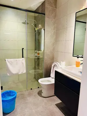 a bathroom with a shower and a toilet and a sink at Akson Residensi Axon Bukit Bintang by TaheeenS in Kuala Lumpur