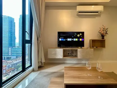 a living room with a tv and a large window at KL Sentral 16th Floor KL City View in Kuala Lumpur