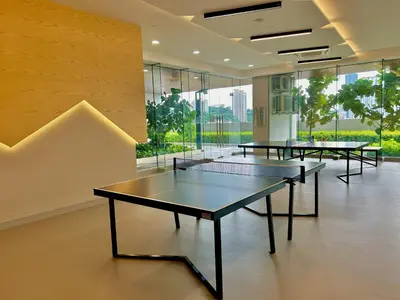 a row of tables in a room with windows at KL Sentral 16th Floor KL City View in Kuala Lumpur