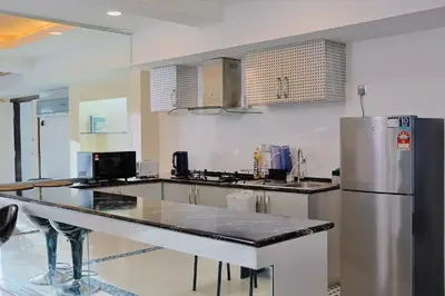 a large kitchen with a stainless steel refrigerator at 3BR at Holiday Place Kuala Lumpur 5 mins to KLCC & MRT in Kuala Lumpur