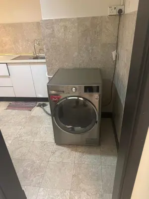 a washing machine in the corner of a kitchen at Services Star Apartment At Times Square KL in Kuala Lumpur