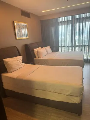 a hotel room with two beds and a window at Services Star Apartment At Times Square KL in Kuala Lumpur