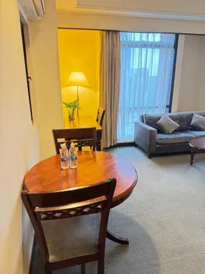 a living room with a wooden table and a couch at Services Star Apartment At Times Square KL in Kuala Lumpur