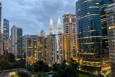 a city skyline at night with tall buildings at Manor Residences KLCC in Kuala Lumpur