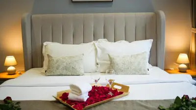 a hotel room with two beds with towels and wine glasses at Manor Residences KLCC in Kuala Lumpur
